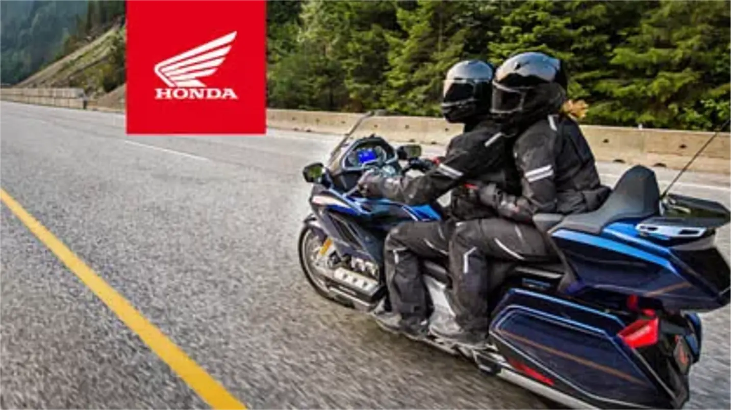 Honda motorcycle cruising along a scenic road