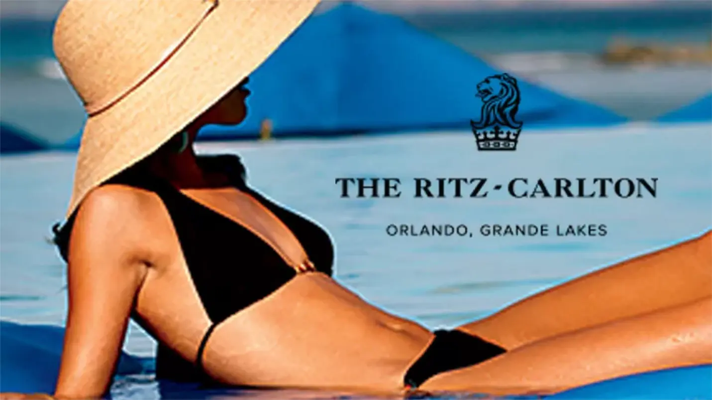Woman enjoying poolside luxury at The Ritz-Carlton
